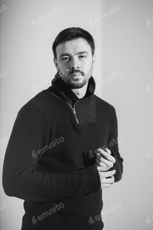 Preview: Vertical greyscale portrait of a young caucasian male in a black sweater