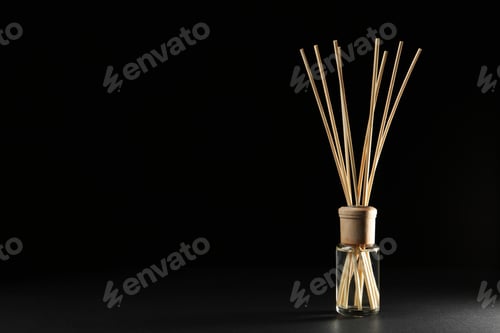 Preview: Reed air freshener on black background, space for text