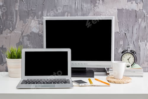 Preview: Modern workspace setup featuring technology and personal items for productivity in a contemporary