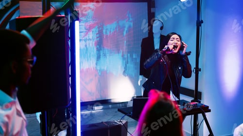 Preview: Young adult partying on stage at club