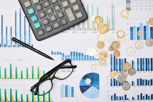 Preview: top view of papers, pen, calculator, coins and glasses on table