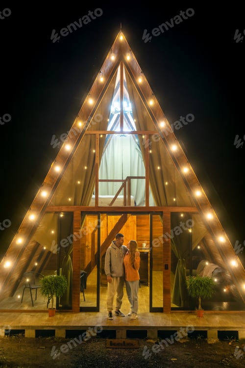 Preview: Couple near the A-frame house in the evening