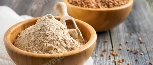 Preview: Buckwheat flour in a bamboo bowl on the old wooden background. Selective focus