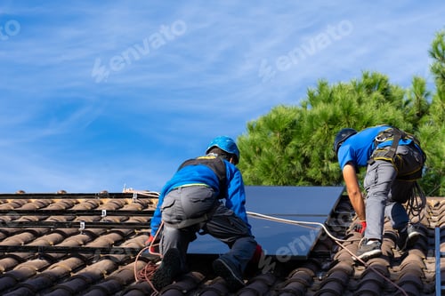 Preview: Solar panel installers installing solar panels on a roof