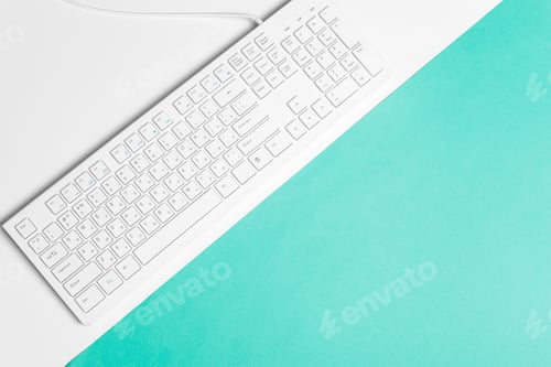 Preview: Computer keyboard on a turquoise paper background