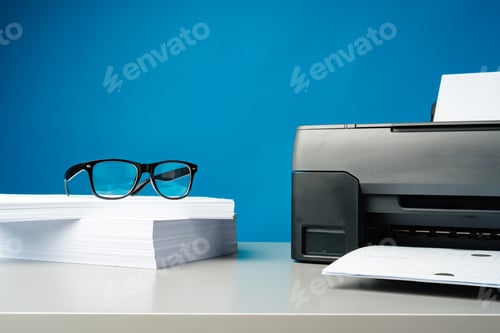 Preview: Laser printer on desk against blue background.
