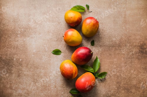 Preview: Mango background design concept. Top view of fresh mango fruit pattern with leaves on table.