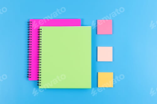 Preview: Colourful stationery on blue background, top view.