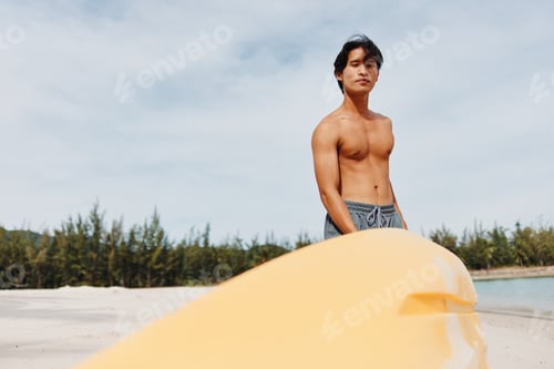 Preview: Happy Asian Man Kayaking on a Tropical Beach Vacation