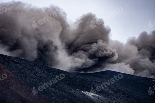 Preview: Closeup shot of the famous Etna volcano smoky and ashy top under a cloudy sky in Sicily, Italy