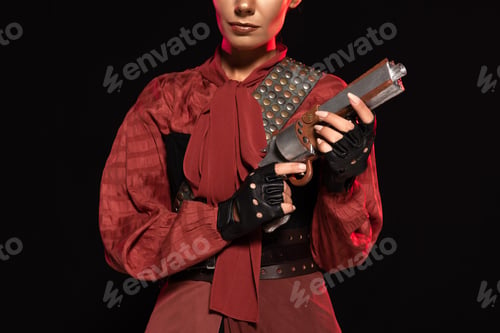 Preview: cropped view of steampunk young woman holding pistol isolated on black