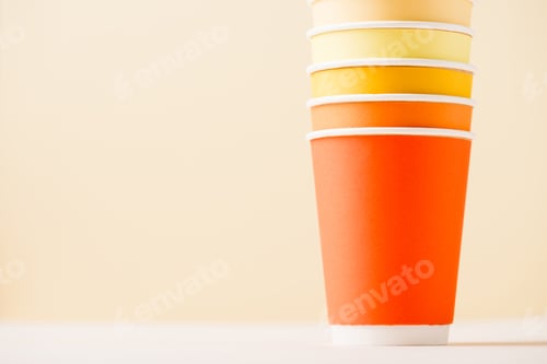 Preview: colorful disposable cups on white surface isolated on beige