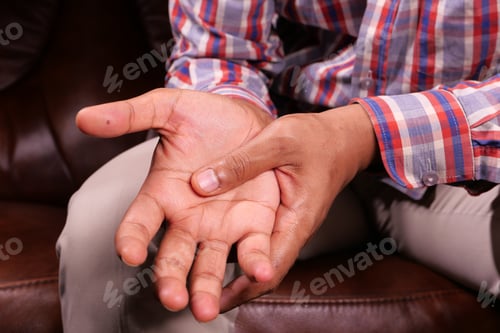 Preview: man suffering pain in hand close up
