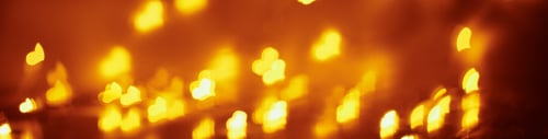 Preview: Abstract background with a golden blurred lights in heart shape. Valentine day concept