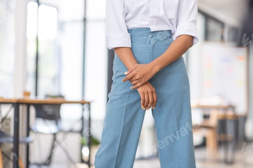 Preview: Female african american business woman in at the workplace, standing confidently. Attractive young