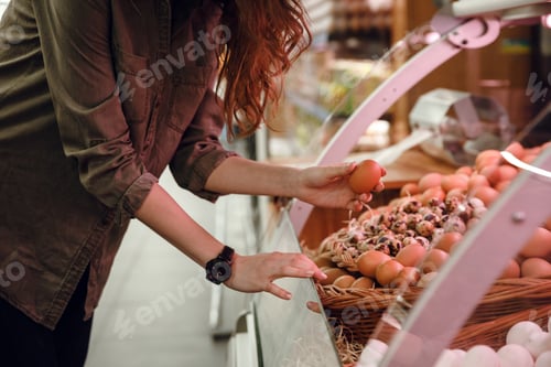 Preview: Side view of woman choosing eggs