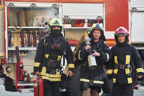 Preview: Group of firefighters in protective uniform that outdoors near truck