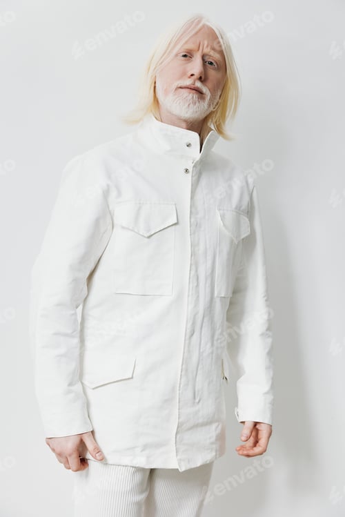 Preview: Fashion model in white attire against a minimalist background, showcasing contemporary style and