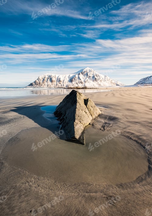 Preview: Puddle sand and rock with snowy mountain