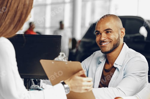 Preview: Woman car salesperson showing something on clipboard to male client