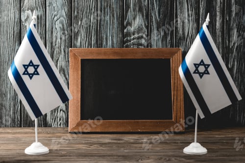 Preview: national israel flags with star of david near empty chalkboard
