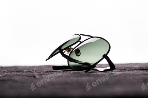 Preview: Close up black sunglasses on a dark table.