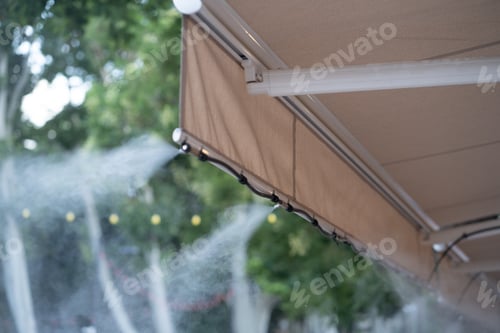 Preview: Facility that lowers temperature by spraying water. Water fog machine working during hot summer day