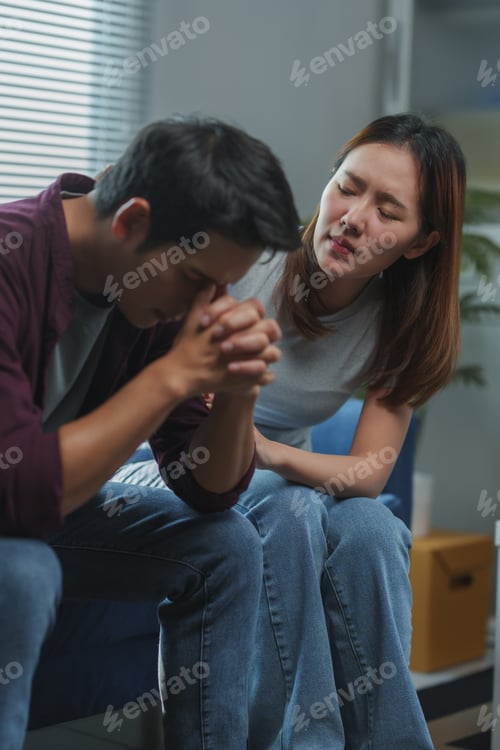 Preview: Young woman comforting sad husband at home