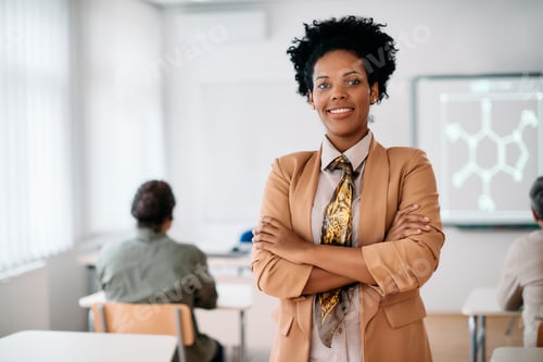 Preview: Portrait of happy confident African American teacher in the classroom looking at camera.
