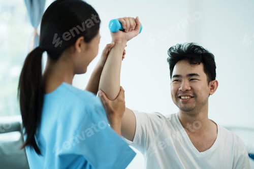 Preview: Physiotherapist treating rehabilitation arm pain patient doing physical therapy exercises.