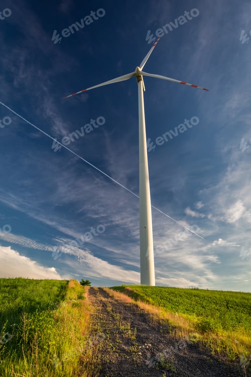 Preview: White wind turbines on a sunny day as alternative energy