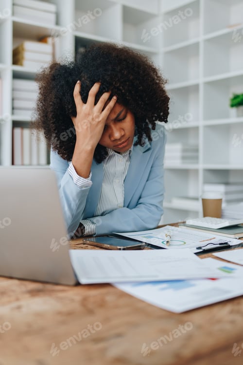 Preview: Burnout American African business woman in stress works with many paperwork document migraine attack