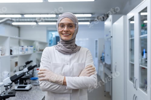 Preview: Portrait of a young Muslim woman laboratory technician, scientist, chemist, biologist wearing a