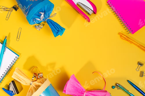 Preview: The image features a yellow background covered with various office supplies and school cones