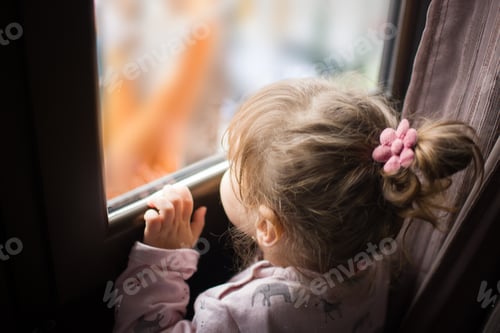 Preview: little girl looking out the window