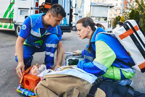 Preview: Paramedics immobilized senior patient with neck brace and spinal board to prevent damage in case of