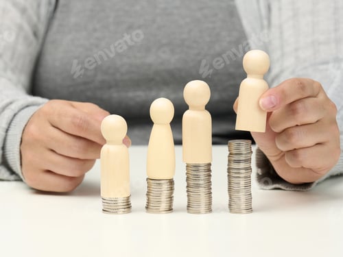 Preview: Wooden figures of men stand on stacks of coins, a white table.