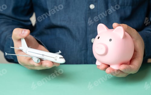 Preview: A man holds an airplane and a piggy bank. Travel savings. Budget flights. Cheap tickets.