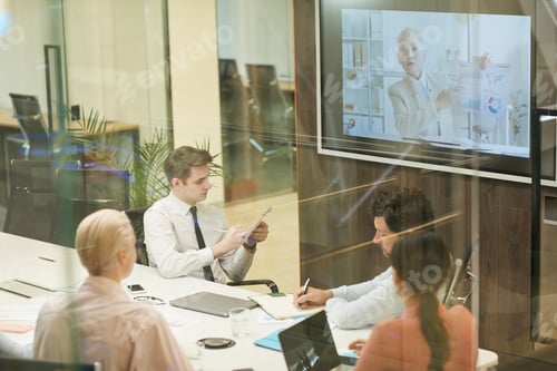 Preview: People sitting at online conference at office