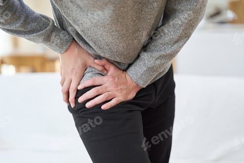 Preview: Asian man suffering from hip pain