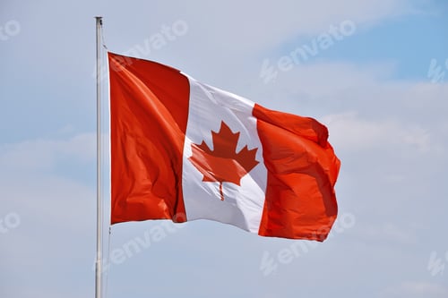 Preview: Canadian flag waving in cloudy blue sky