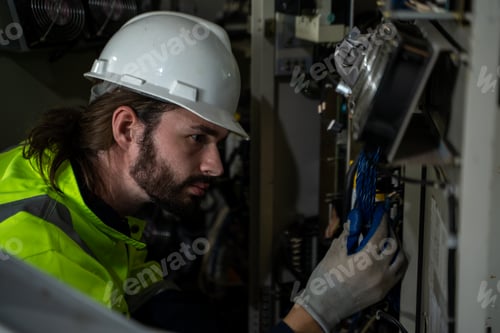 Preview: Engineer inspect robotic arm in workshop.