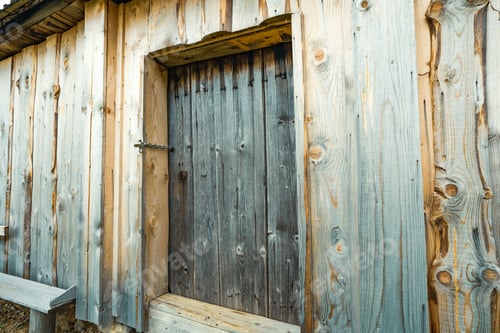 Preview: Small closed door in the wooden wall of an old house