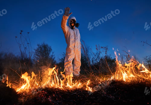 Preview: Firefighter ecologist working in field with wildfire.
