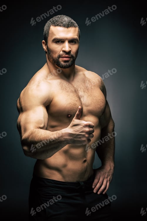 Preview: portrait of shirtless athletic man showing thumb up isolated on black