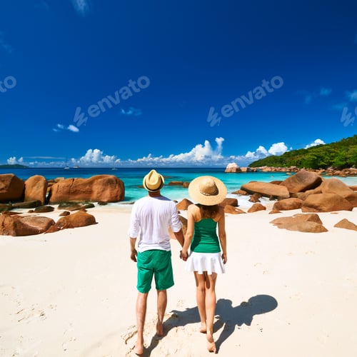 Preview: Couple In Green On A Tropical Beach At Seychelles