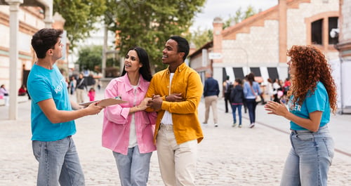 Preview: Volunteers Engaging with a Couple at an Outdoor Event