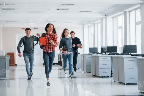 Preview: Running forward. Group of young people walking in the office at their break time
