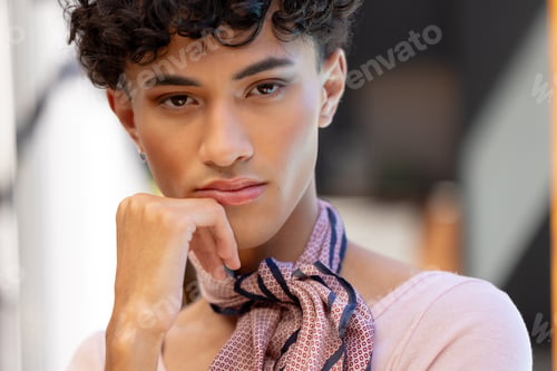 Preview: Close-up of transgender transgender woman resting chin on hand, wearing patterned scarf