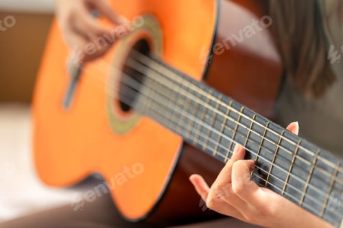 Preview: The girl plays the classical or acoustic guitar. Guitar close-up.